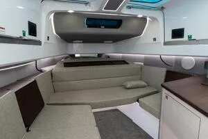 Slide: The Image of 2024 Axopar 45 interior cabin with modern seating and sleek design. - 16