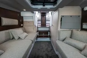 Slide: The Image of 2024 Axopar 45 interior cabin with modern seating and elegant design. - 17