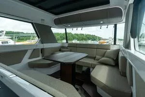 Slide: The Image of Interior of 2024 Axopar 45 boat with modern seating and table arrangement. - 22