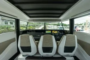 Slide: The Image of 2024 Axopar 45 boat interior with modern seating and dashboard view. - 8