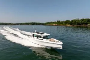 The Image of 2024 Axopar 45 XC Cross Cabin yacht cruising on water, available at East Coast Yacht Sales. - 1