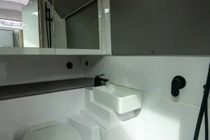 Slide: The Image of 2024 Axopar 45 XC Cross Cabin interior with modern seating and wooden accents. - 14