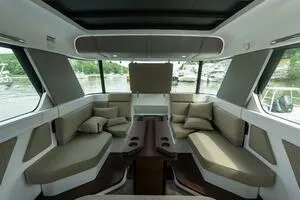 Slide: The Image of 2024 Axopar 45 XC Cross Cabin storage compartment with life jackets and safety gear. - 15