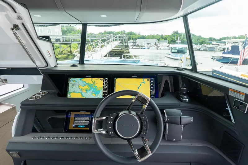 Slide: The Image of 2024 Axopar 45 XC Cross Cabin helm with advanced navigation displays and sleek design. - 26