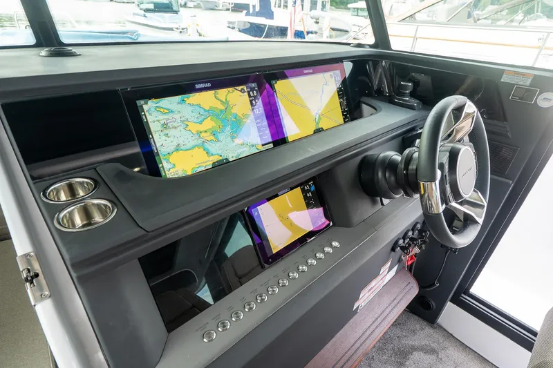 Slide: The Image of 2024 Axopar 45 XC Cross Cabin dashboard with navigation screens and steering wheel. - 27