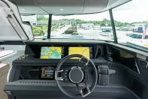 Slide: The Image of 2024 Axopar 45 XC Cross Cabin cruising on open water, showcasing sleek design and performance. - 7