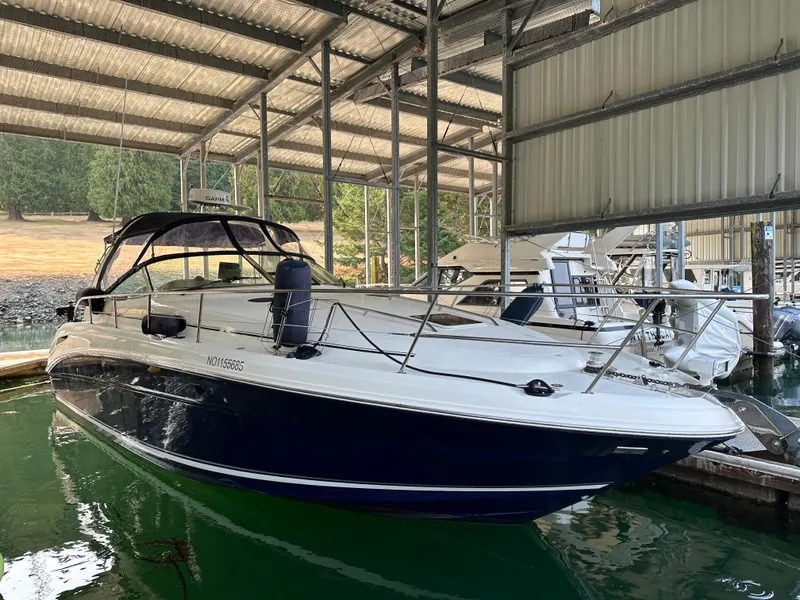 The Image of 2004 Sea Ray 360 Sundancer docked in a covered marina, side view. - 0