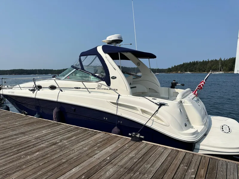 Slide: The Image of 2004 Sea Ray 360 Sundancer docked by a scenic waterfront. - 1