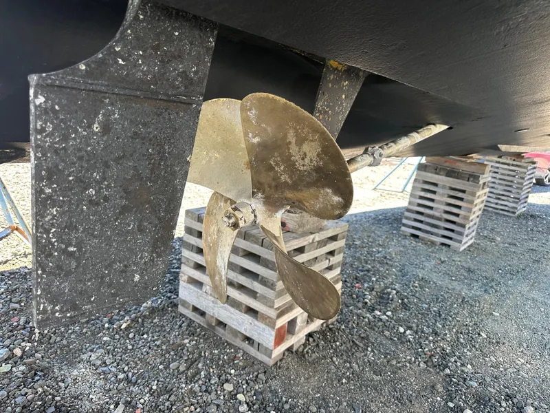 Slide: The Image of Propeller of 2004 Sea Ray 360 Sundancer on wooden blocks, showcasing boat maintenance. - 11