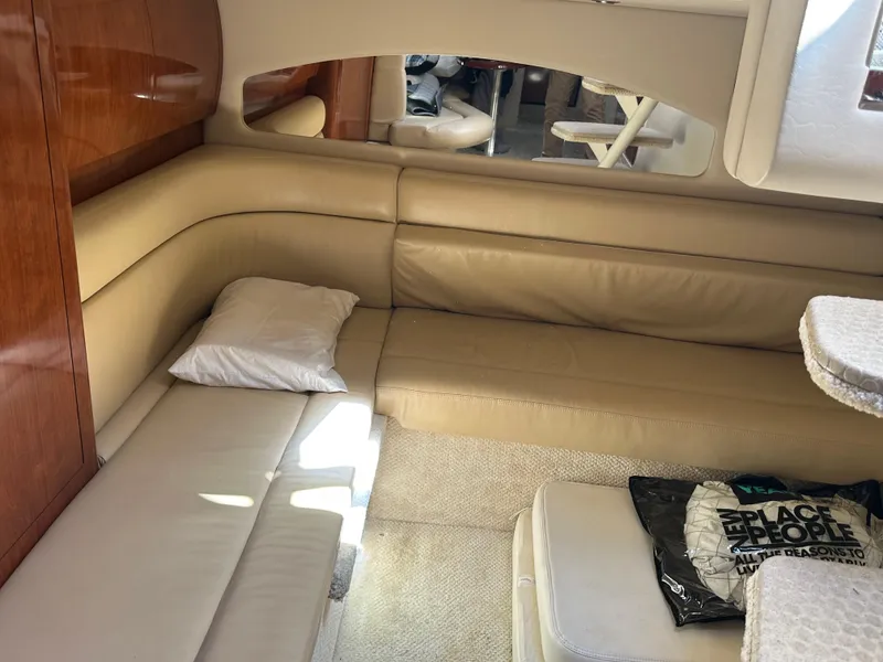 Slide: The Image of 2004 Sea Ray 360 Sundancer interior with beige seating and wooden accents. - 12