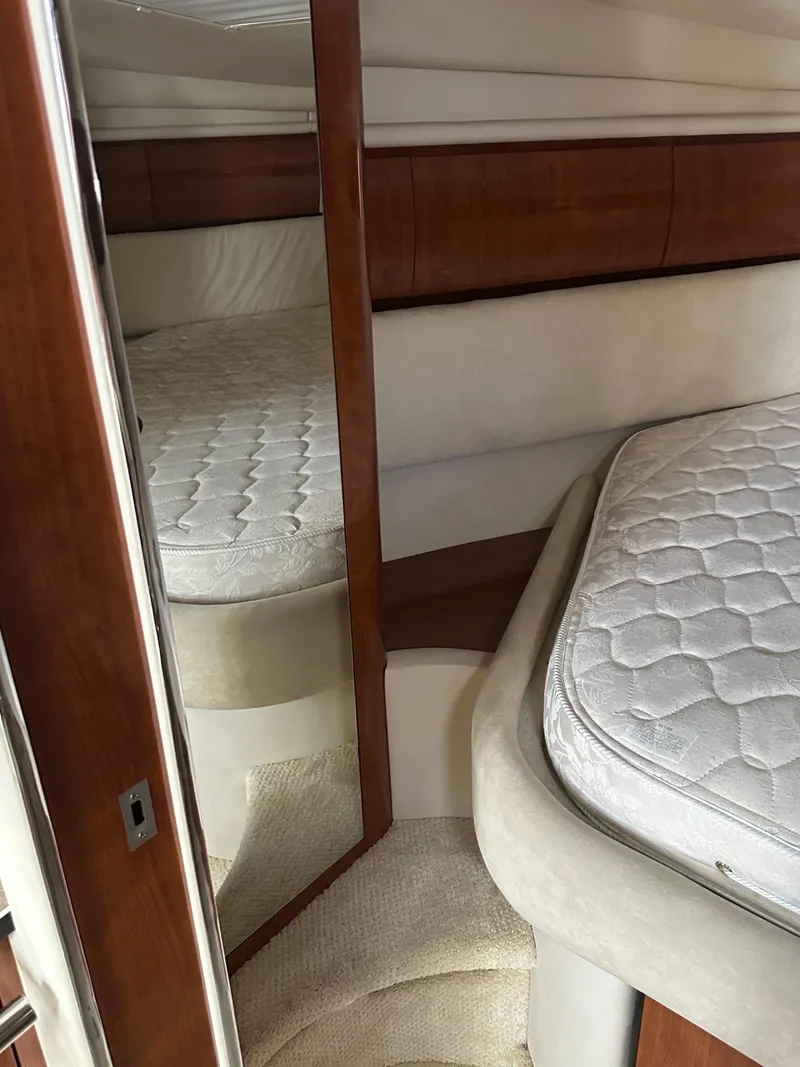 Slide: The Image of 2004 Sea Ray 360 Sundancer cabin interior with bed and mirror. - 16