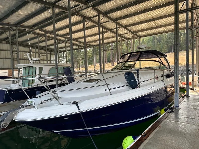 Slide: The Image of 2004 Sea Ray 360 Sundancer docked in a covered marina. - 2