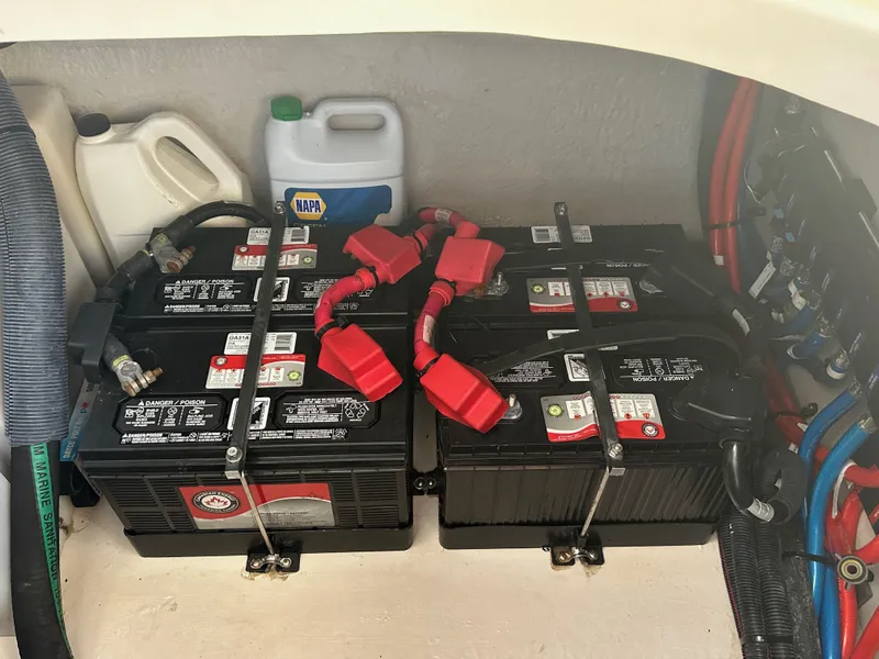 Slide: The Image of Batteries and containers in a 2004 Sea Ray 360 Sundancer boat compartment. - 24