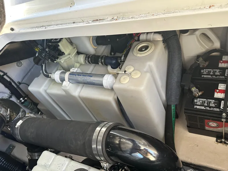 Slide: The Image of Engine compartment of a 2004 Sea Ray 360 Sundancer boat, showing components and battery. - 26