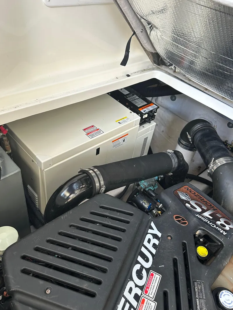 Slide: The Image of Engine compartment of a 2004 Sea Ray 360 Sundancer with Mercury components. - 28