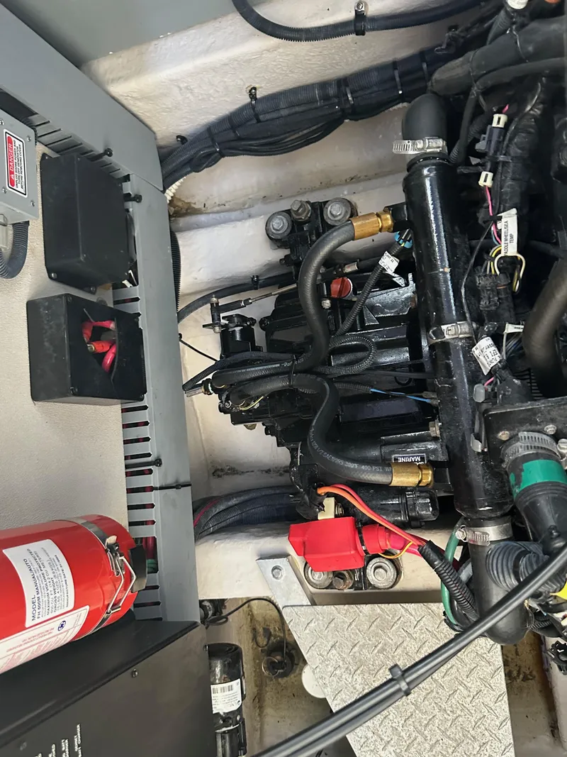 Slide: The Image of Engine compartment of a 2004 Sea Ray 360 Sundancer with visible wiring and fire extinguisher. - 29