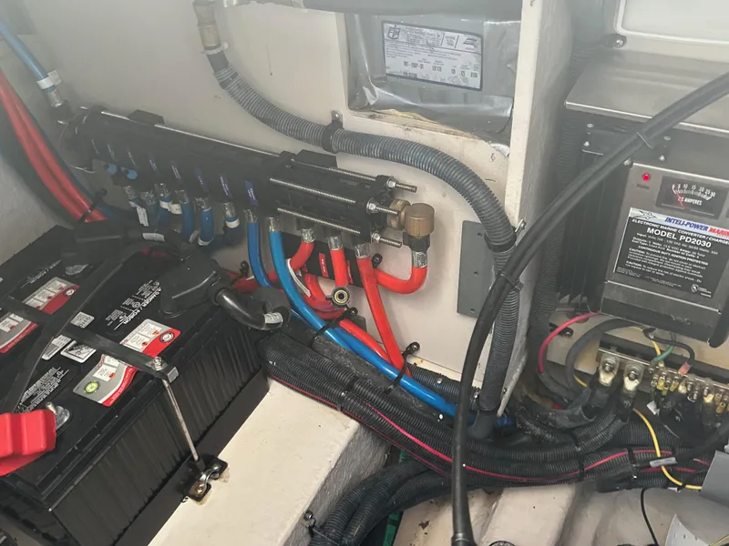 Slide: The Image of Engine compartment of a 2004 Sea Ray 360 Sundancer with batteries and wiring. - 31