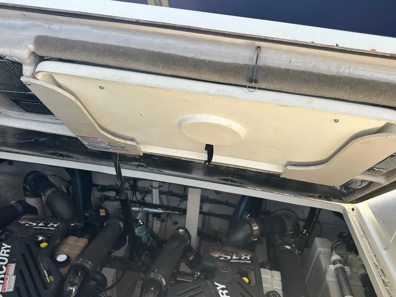 Slide: The Image of Engine compartment of a 2004 Sea Ray 360 Sundancer boat, featuring Mercury engines. - 32