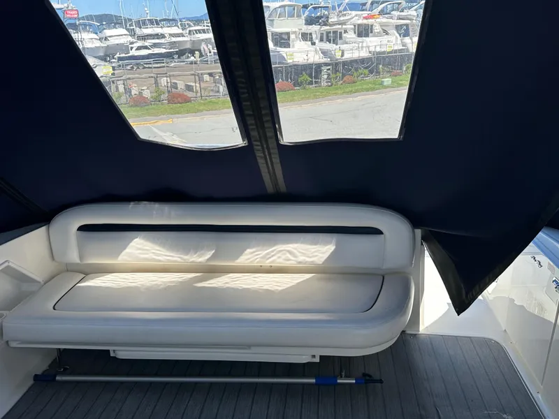 Slide: The Image of 2004 Sea Ray 360 Sundancer interior with cushioned seating and marina view. - 33