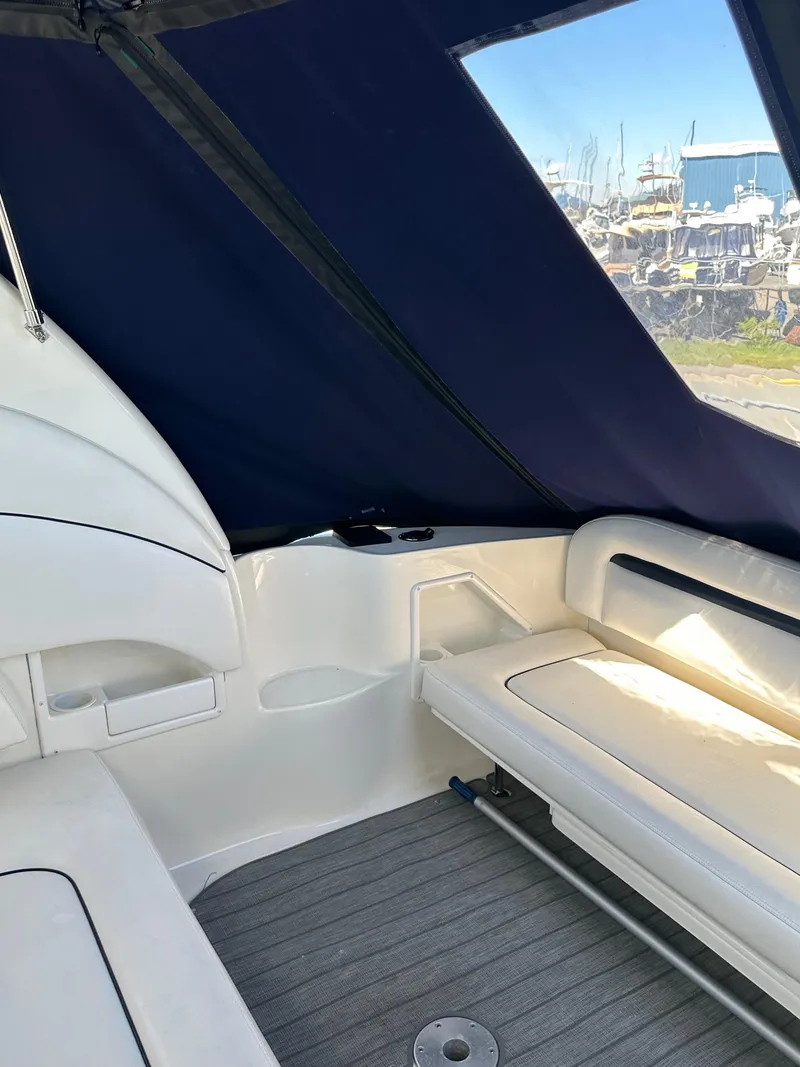 Slide: The Image of 2004 Sea Ray 360 Sundancer interior with seating and blue canopy. - 34