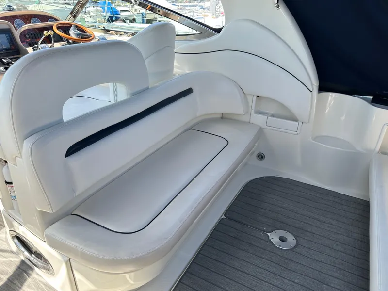 Slide: The Image of 2004 Sea Ray 360 Sundancer interior with white seating and modern dashboard. - 36