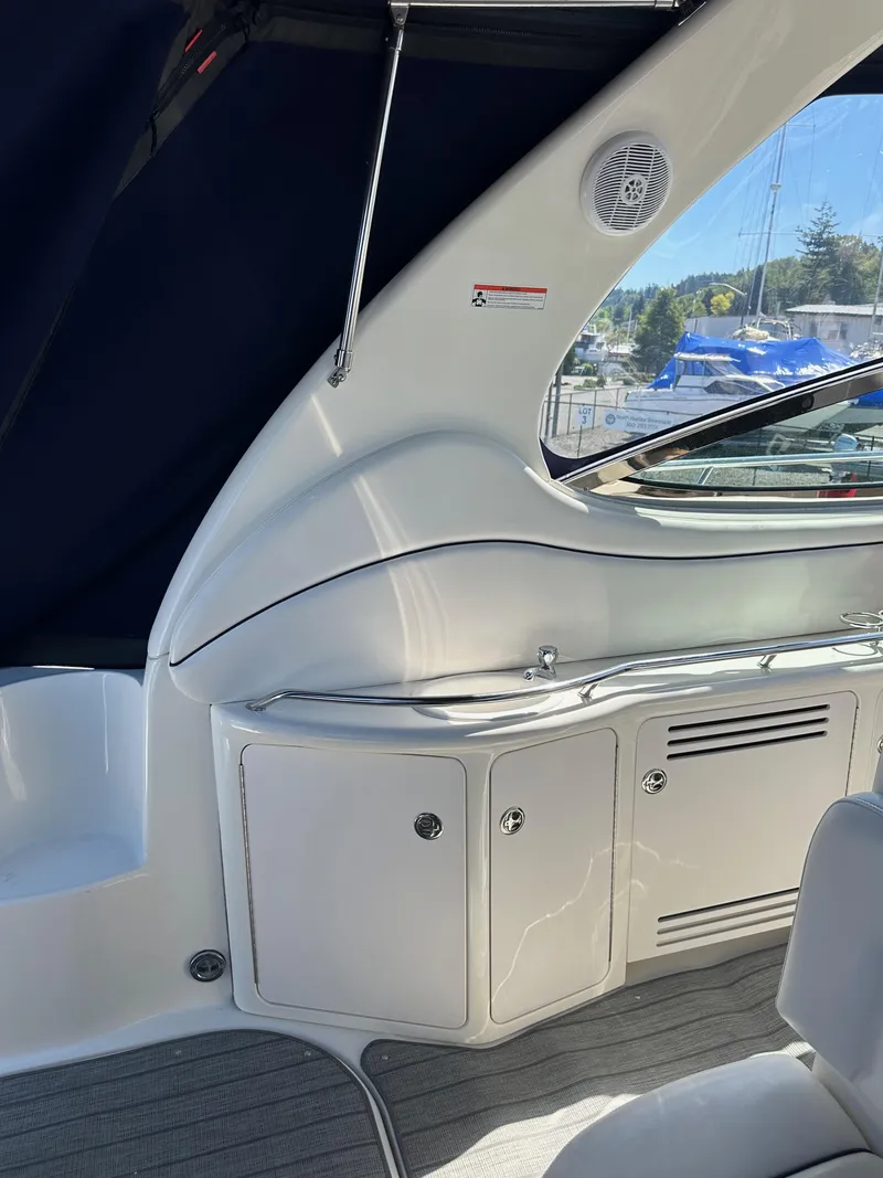 Slide: The Image of 2004 Sea Ray 360 Sundancer interior with sleek white cabinetry and modern design. - 38