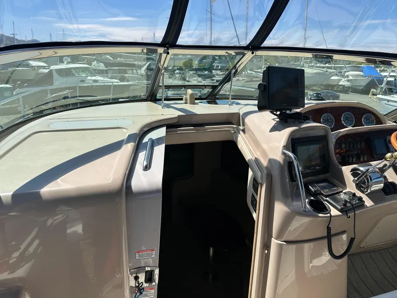 Slide: The Image of 2004 Sea Ray 360 Sundancer helm with navigation equipment and marina view. - 39