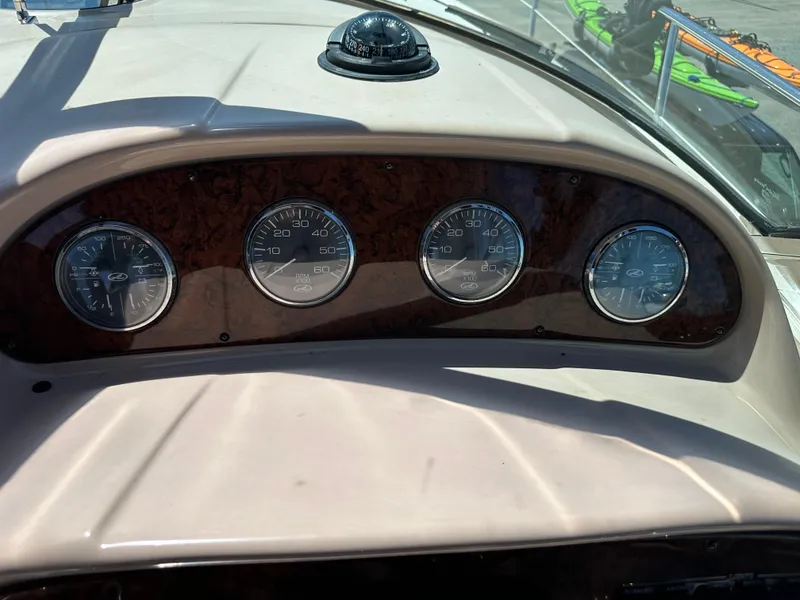 Slide: The Image of Dashboard of 2004 Sea Ray 360 Sundancer with gauges and compass in sunlight. - 44