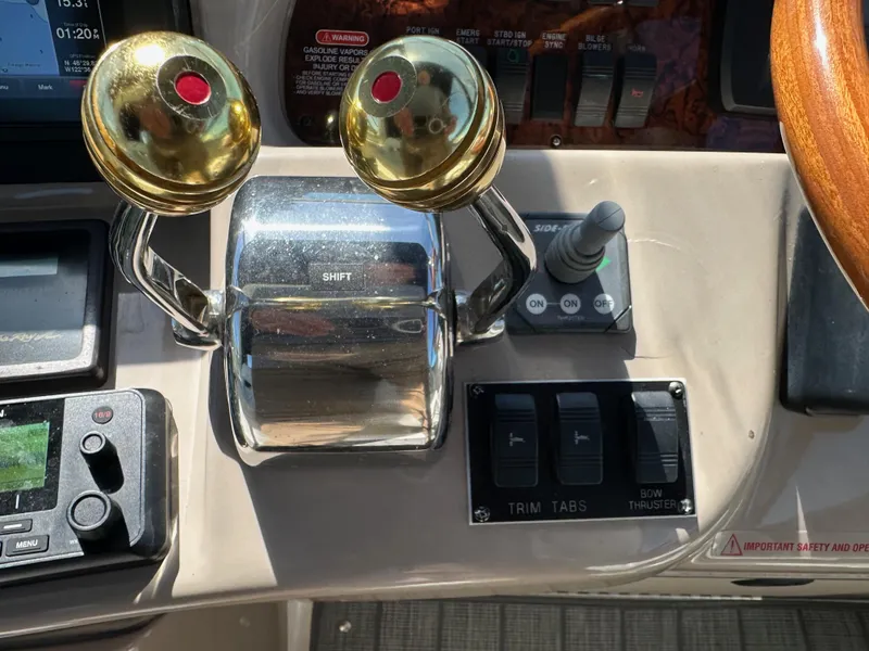 Slide: The Image of Control panel of a 2004 Sea Ray 360 Sundancer boat with throttle and navigation controls. - 45