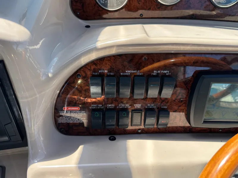 Slide: The Image of Control panel of a 2004 Sea Ray 360 Sundancer boat with switches and gauges. - 46