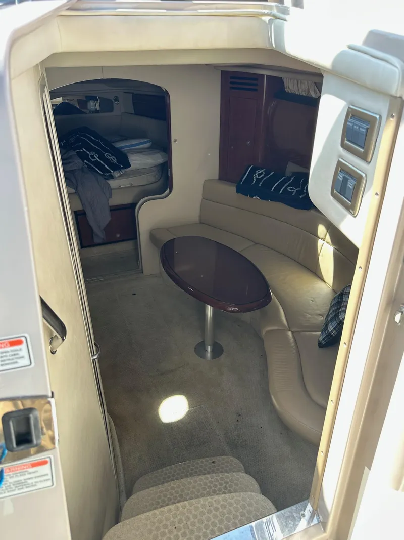 Slide: The Image of 2004 Sea Ray 360 Sundancer cabin interior with seating and table. - 49