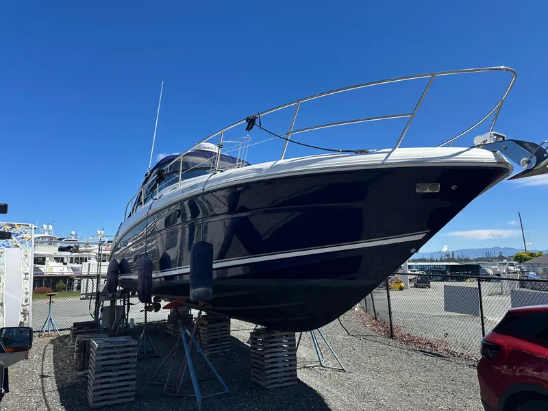 Slide: The Image of 2004 Sea Ray 360 Sundancer yacht on dry dock under clear blue sky. - 7