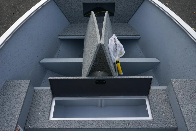 Slide: The Image of 2025 Lund 1600 Fury Tiller boat interior with storage compartments and fishing net. - 11