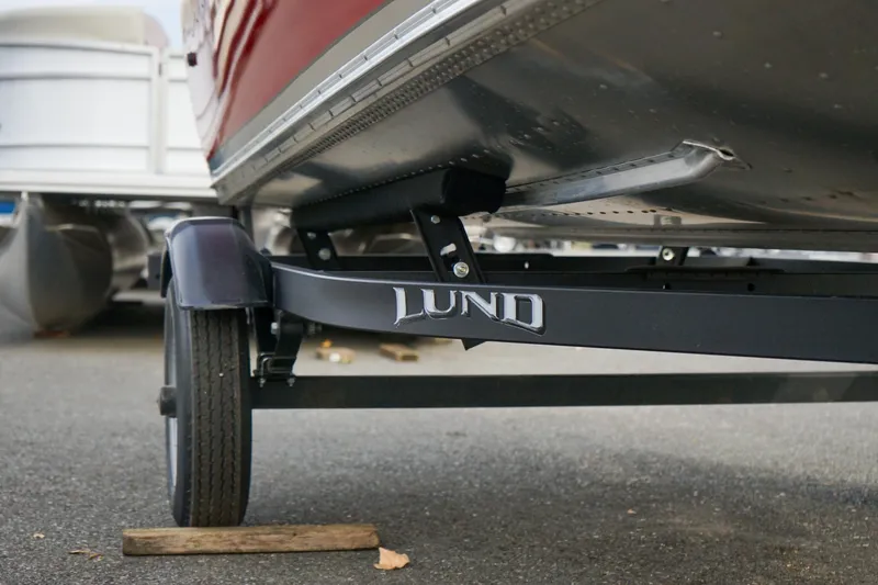 Slide: The Image of 2025 Lund 1600 Fury Tiller boat on trailer, close-up view. - 13