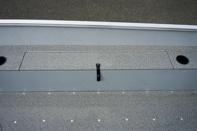 Slide: The Image of 2025 Lund 1600 Fury Tiller boat deck with storage compartment and textured surface. - 15