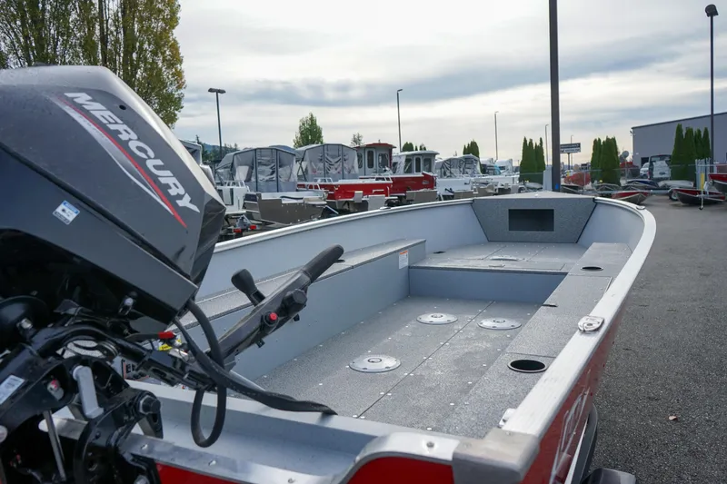 Slide: The Image of 2025 Lund 1600 Fury Tiller boat with Mercury engine, parked outdoors. - 5