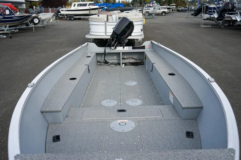 Slide: The Image of 2025 Lund 1600 Fury Tiller boat, spacious interior, parked in a marina. - 6