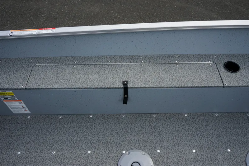 Slide: The Image of 2025 Lund 1600 Fury Tiller boat interior with storage compartment and cup holder. - 7