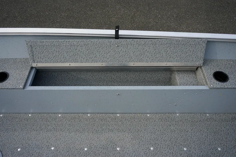 Slide: The Image of 2025 Lund 1600 Fury Tiller boat interior with storage compartment and cup holders. - 8