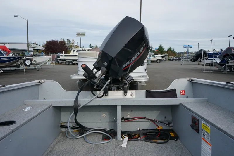 Slide: The Image of 2025 Lund 1600 Fury Tiller boat with Mercury engine, displayed in a dealership lot. - 9