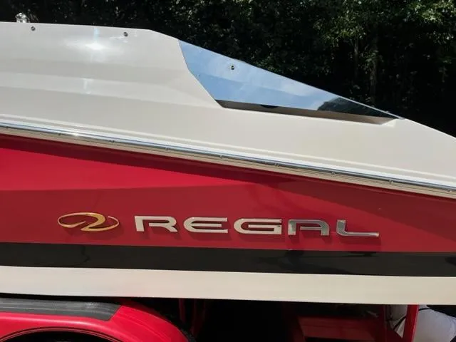 Slide: The Image of 2007 Regal 2200 Bowrider boat, red and white exterior, side view with logo. - 11