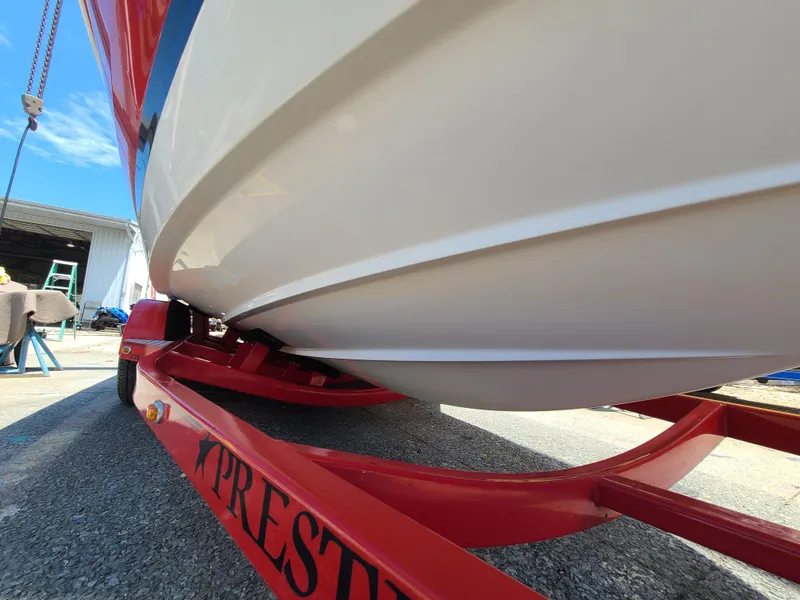 Slide: The Image of 2007 Regal 2200 Bowrider on red trailer, close-up view of hull. - 12