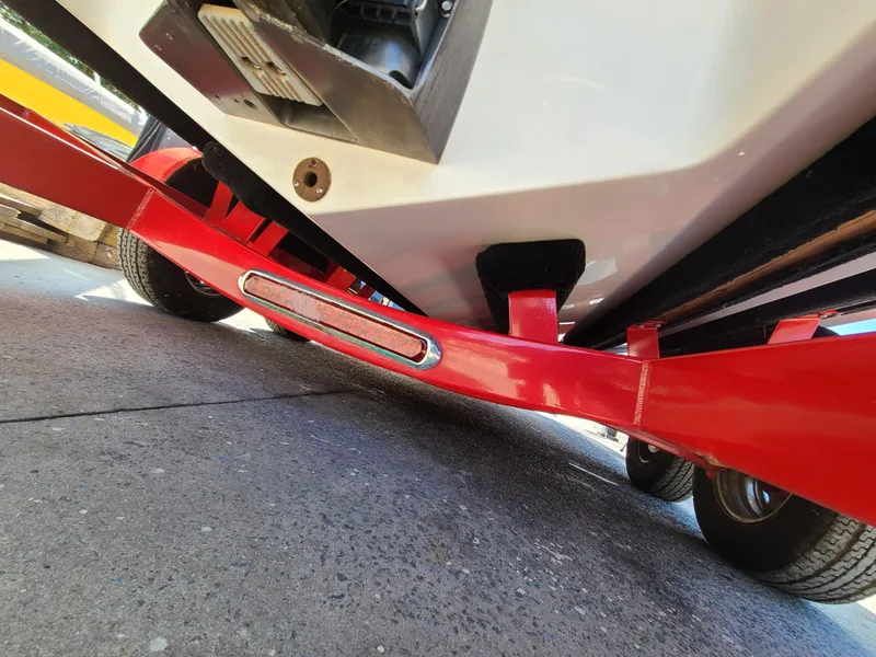 Slide: The Image of 2007 Regal 2200 Bowrider on red trailer, close-up view of hull and trailer frame. - 15