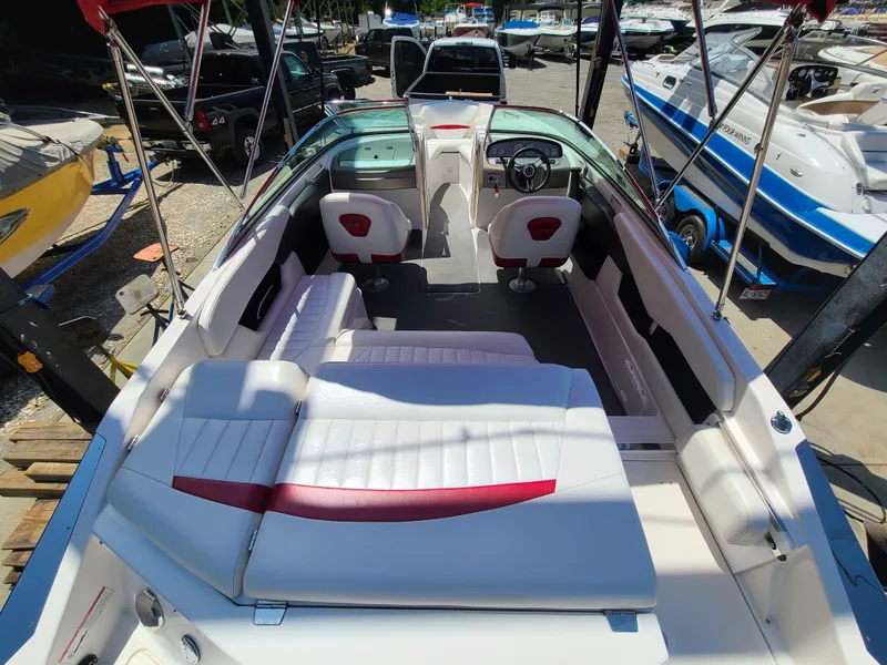 Slide: The Image of 2007 Regal 2200 Bowrider boat interior with white seating and red accents. - 18