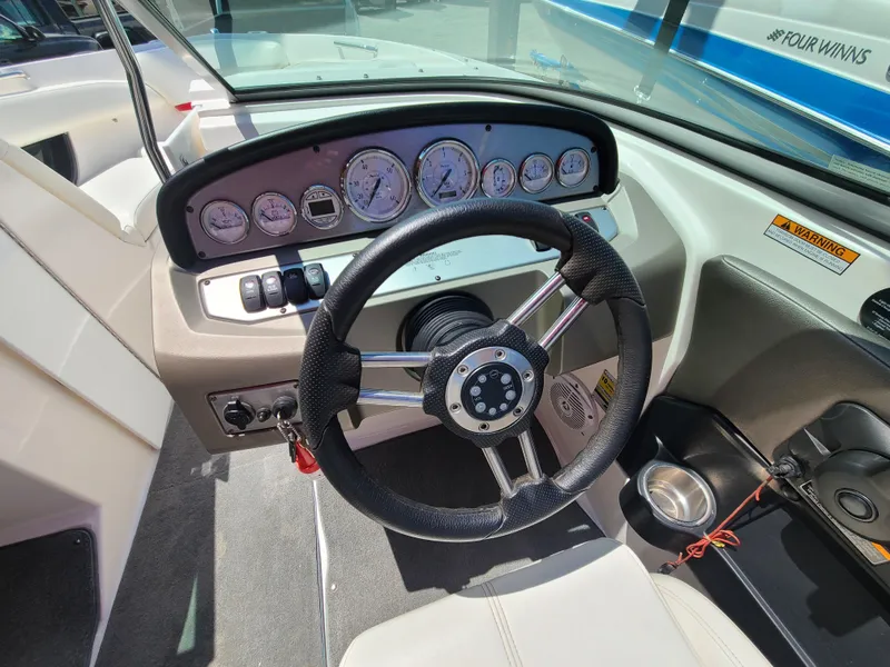 Slide: The Image of 2007 Regal 2200 Bowrider dashboard with steering wheel and instrument panel. - 19