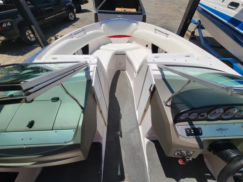 Slide: The Image of 2007 Regal 2200 Bowrider interior with seating and dashboard, parked outdoors. - 21