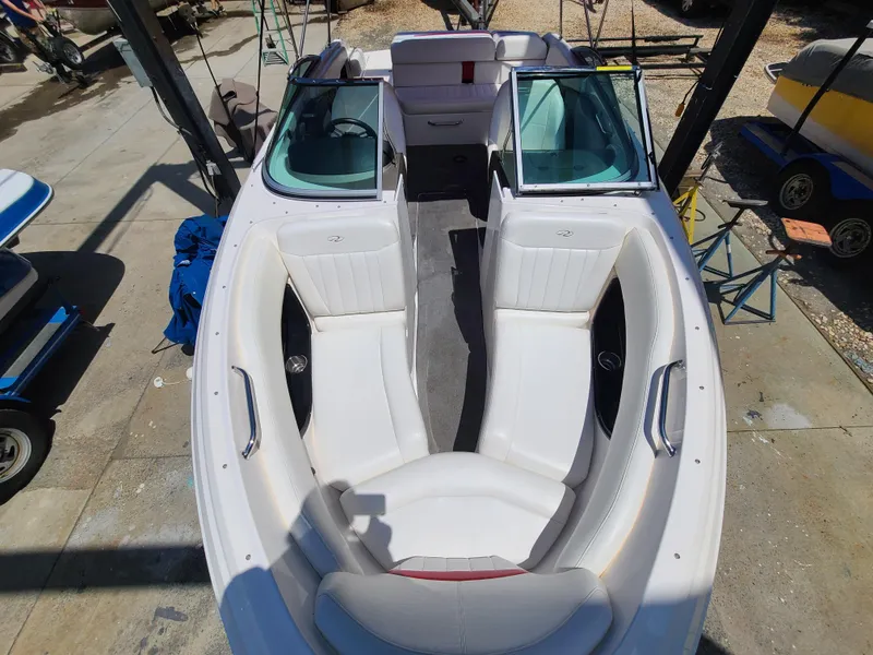 Slide: The Image of 2007 Regal 2200 Bowrider boat with white seating and open bow design. - 23