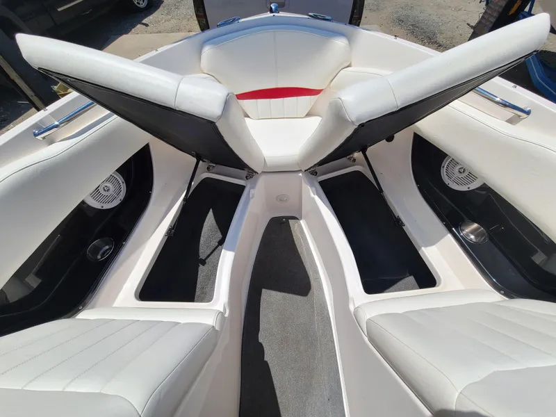 Slide: The Image of 2007 Regal 2200 Bowrider interior with white seating and storage compartments. - 24