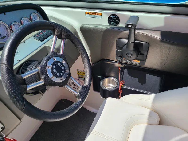 Slide: The Image of 2007 Regal 2200 Bowrider dashboard with steering wheel and throttle controls. - 25