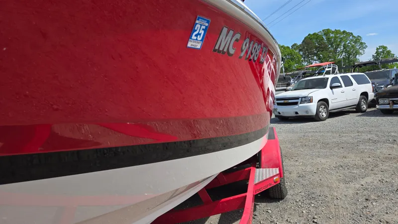 Slide: The Image of Red 2007 Regal 2200 Bowrider boat on trailer in parking lot. - 3